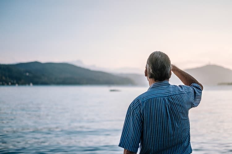 Man looks out at a lake