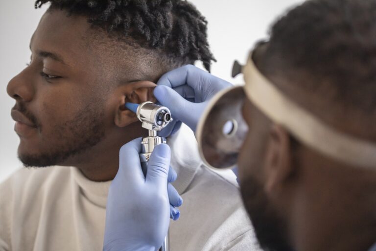 Man gets ear examined by doctor Man gets ear examined by doctor