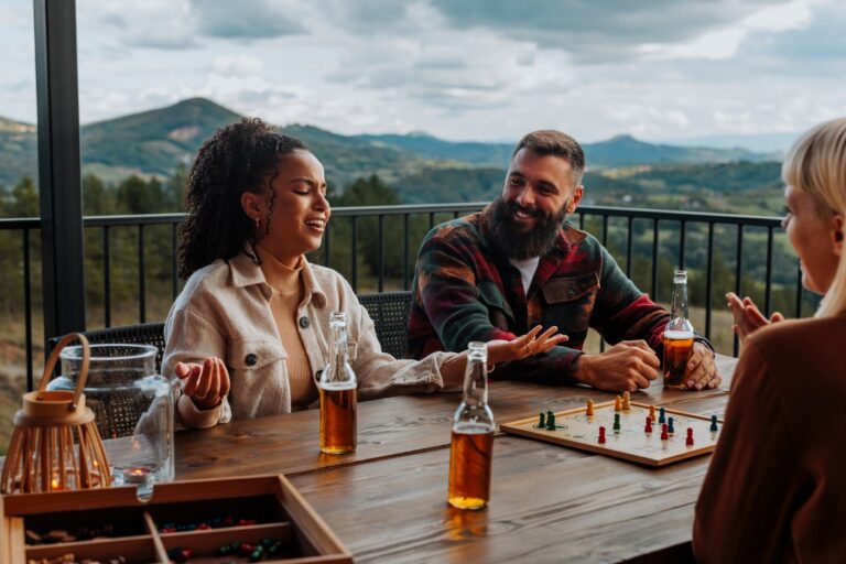 Group of friends playing a board game on a deck