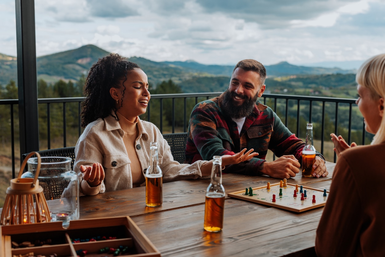 Group of friends playing a board game on a deck