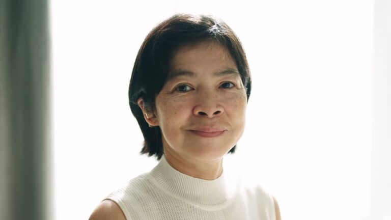 Confident in My Hearing Aids Smiling woman wearing a hearing aid