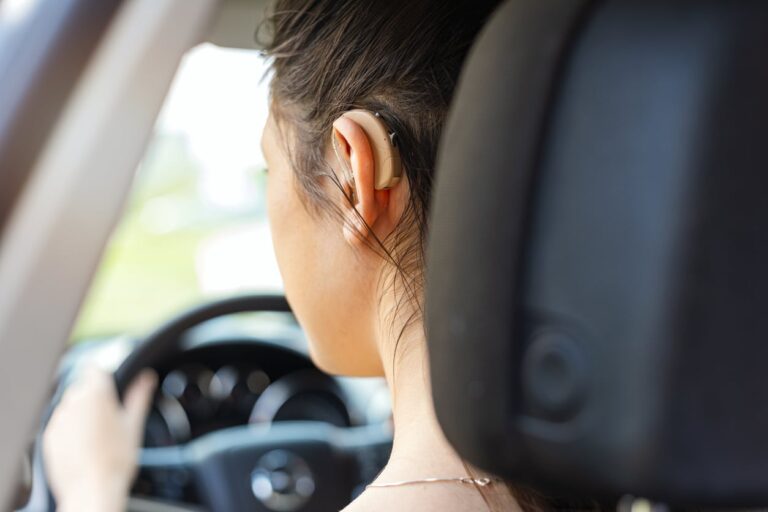 Woman drives with hearing aids Woman drives with hearing aids