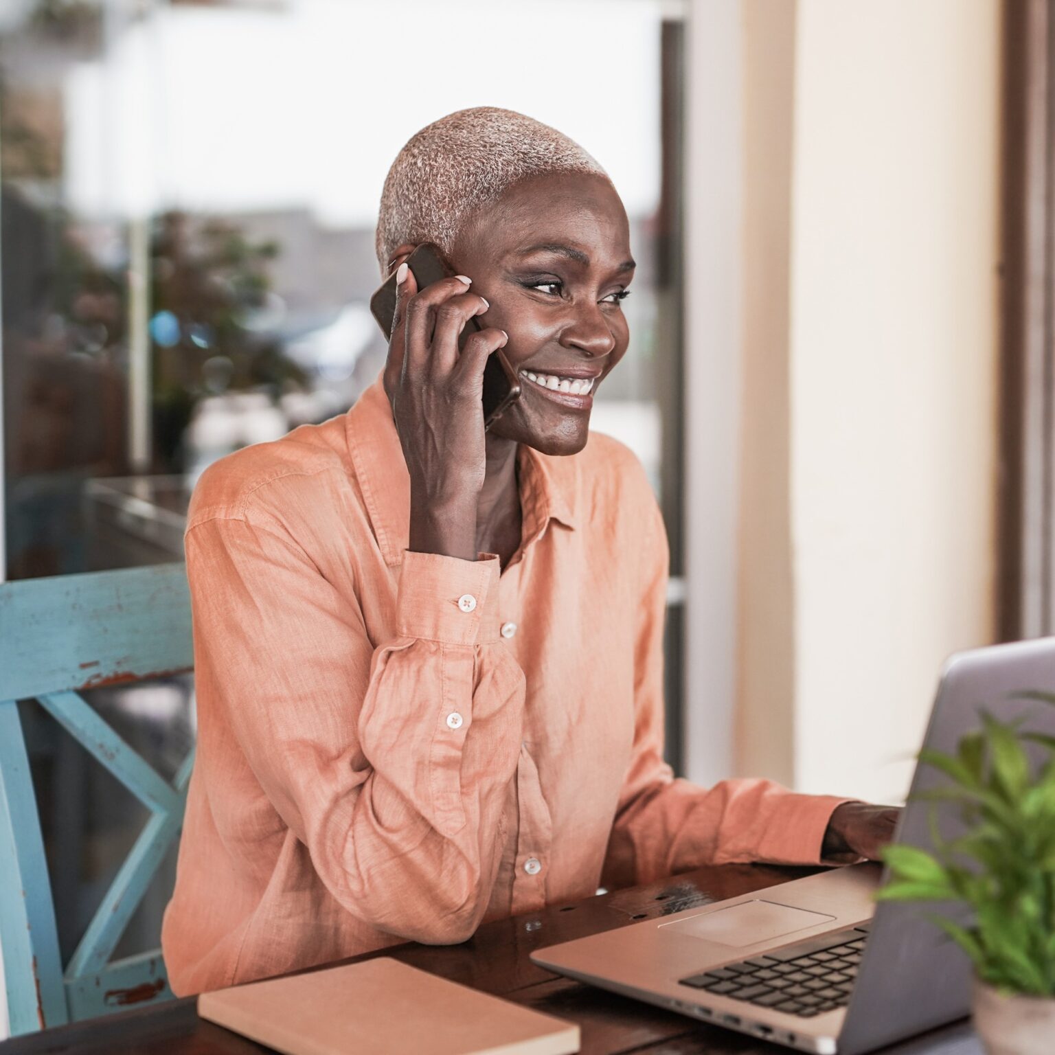 Smiling woman making an appointment over the phone.
