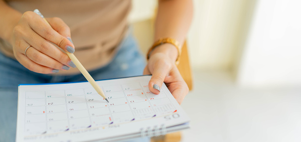 Close up of someone making notes in a calendar